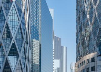 Modern skyscrapers and footbridge against blue sky in La Defense, Paris, France